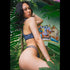 Model with short hair, standing in plants having Daydream Island Bikini Dark Animale Reversible, having silver bracelet