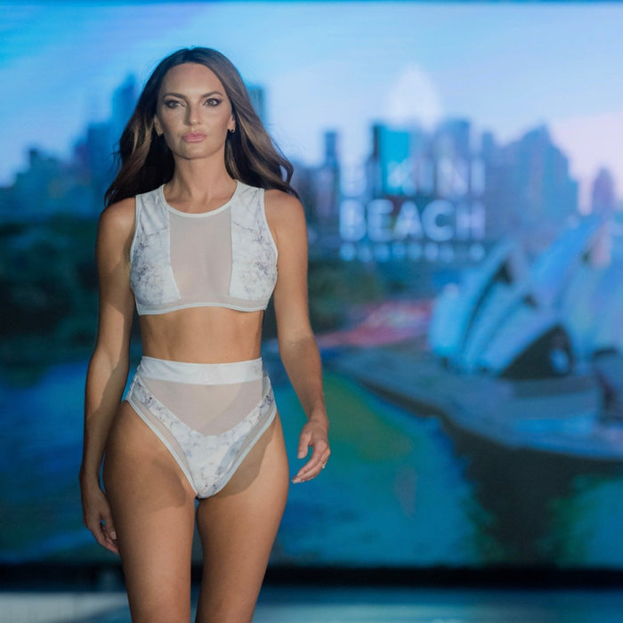 Model with light brown open hair, on a ramp walk, having Hamilton Island Bikini in Frostbite Reversible, High Waisted Cheeky Cut Bottom High waist mesh detailing High neck mesh detailing Back zip crop top Full mesh back detail, BBA