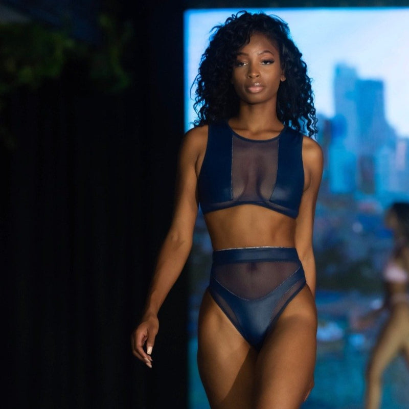 Model with curly hair, having Hamilton Island Bikini in Liquid Navy Reversible, High waisted cheeky cut bottom High waist mesh detailing High neck mesh detailing Back zip crop top, 