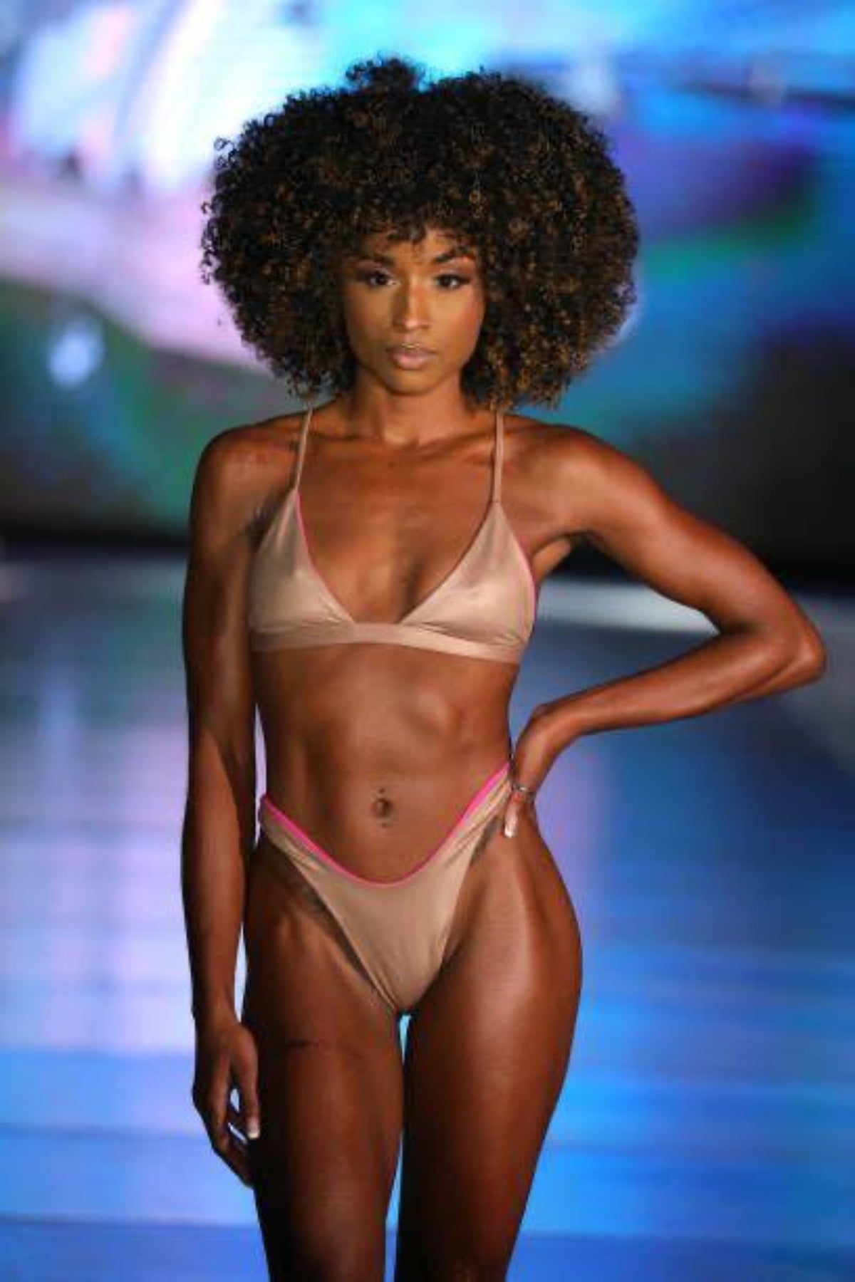 Model on ramp walk, with bulky curly hair, having reversed Pinky Beach Bikini